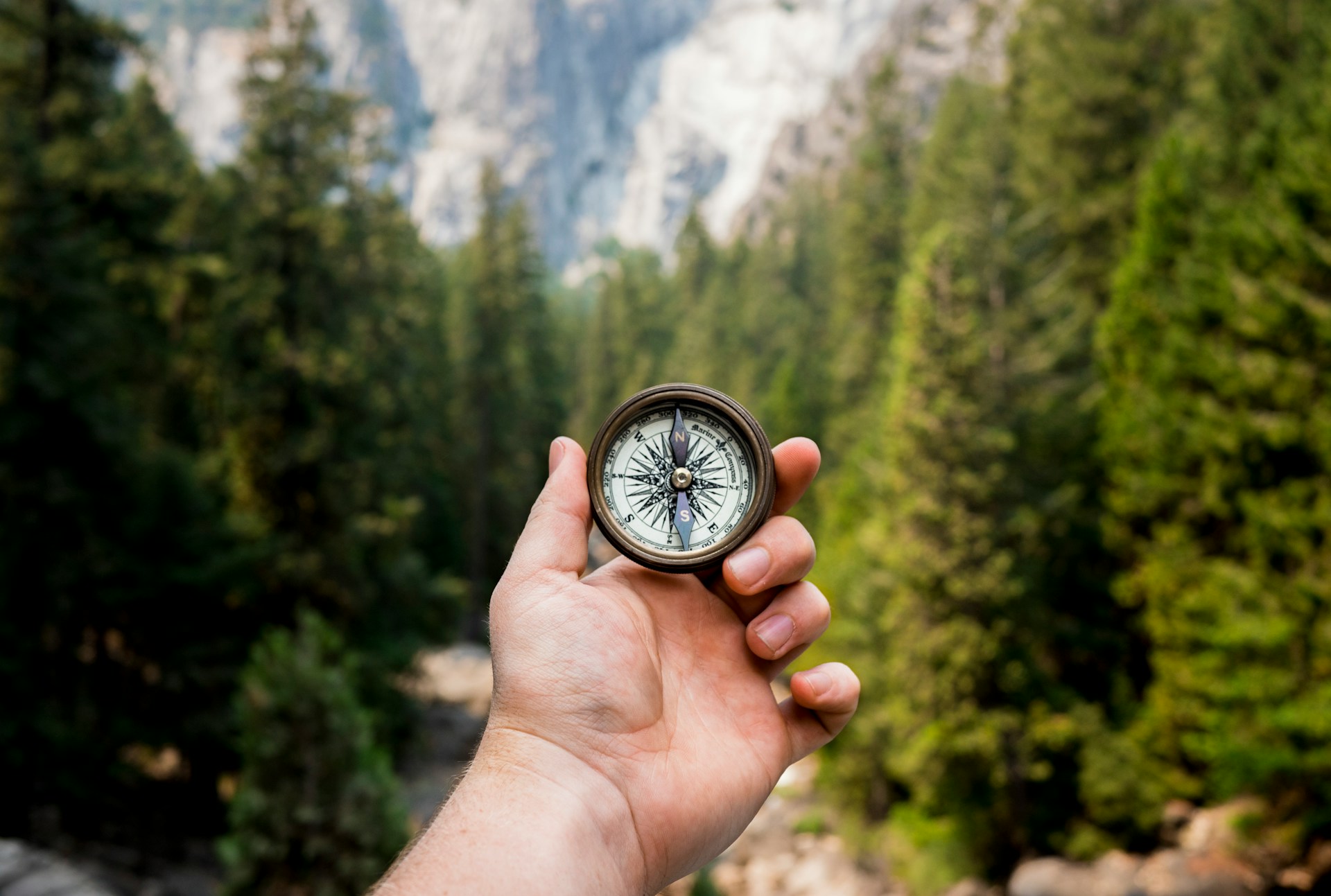 Hand holding compass.